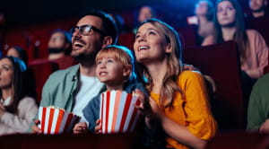 Family at cinema with popcorn
